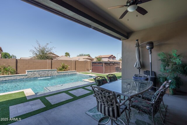 view of swimming pool with outdoor dining space, a fenced backyard, ceiling fan, a hot tub, and a patio area