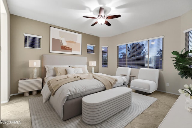 bedroom with a ceiling fan, light tile patterned flooring, and baseboards