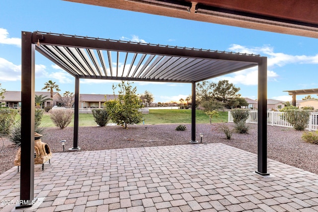 view of patio featuring a residential view, fence, and a pergola