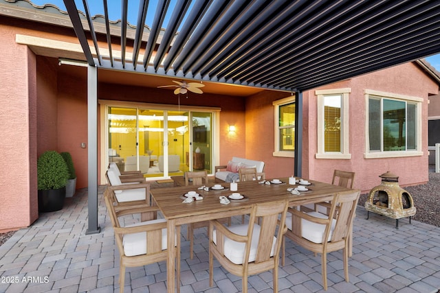 view of patio featuring outdoor dining area and a ceiling fan