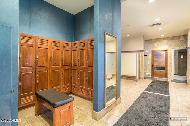 bathroom featuring tile patterned flooring, visible vents, a towering ceiling, and recessed lighting