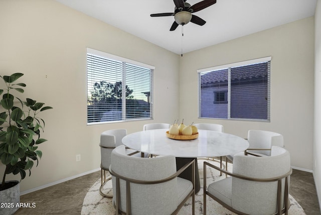 dining area featuring a ceiling fan and baseboards