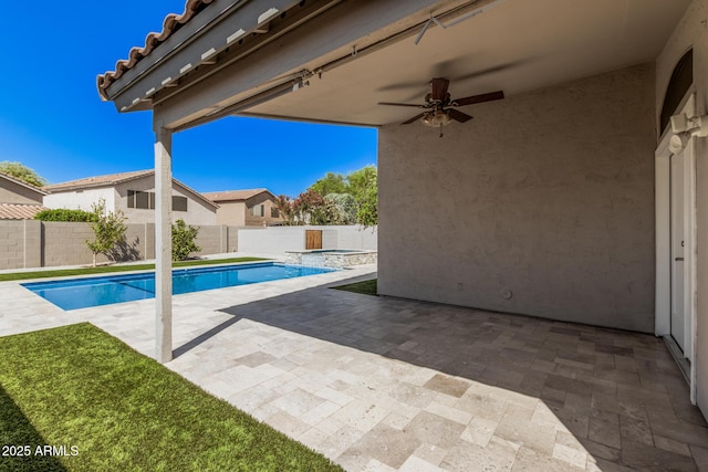 view of pool with a fenced backyard, a ceiling fan, a patio area, and a pool with connected hot tub