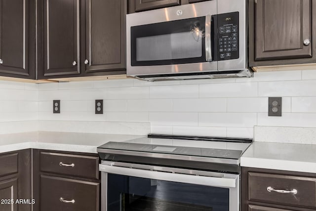 kitchen with light countertops, appliances with stainless steel finishes, tasteful backsplash, and dark brown cabinetry