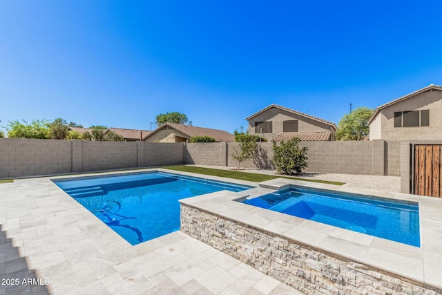 view of swimming pool with an in ground hot tub, a fenced in pool, a fenced backyard, and a patio area