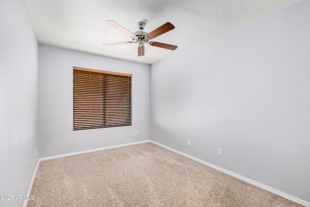 empty room featuring baseboards, carpet flooring, and ceiling fan