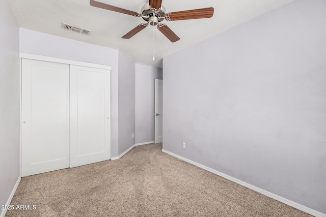 unfurnished bedroom featuring carpet floors, baseboards, visible vents, and a closet