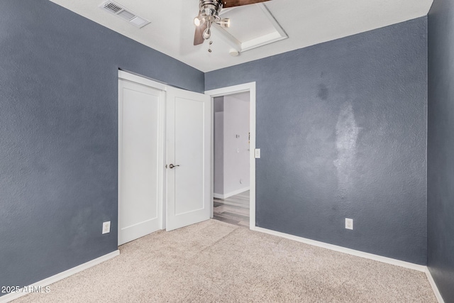 unfurnished bedroom with carpet floors, a ceiling fan, baseboards, and visible vents