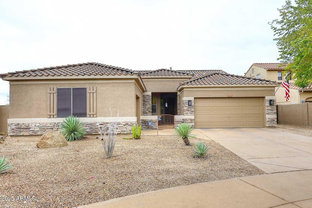 mediterranean / spanish-style home with a garage