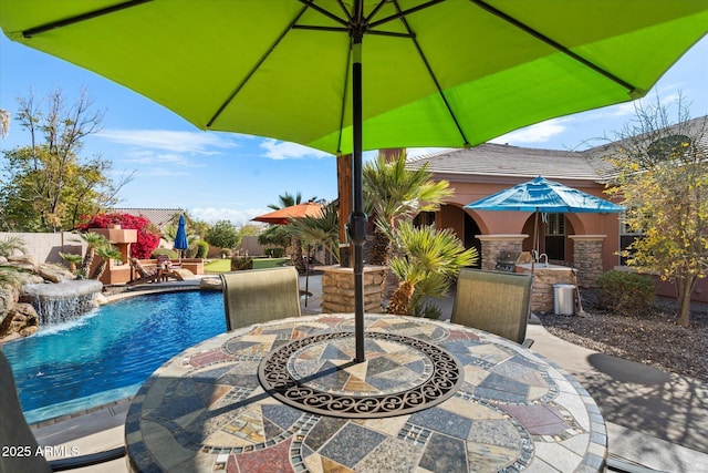 view of swimming pool with outdoor dining area, a fenced in pool, and a patio