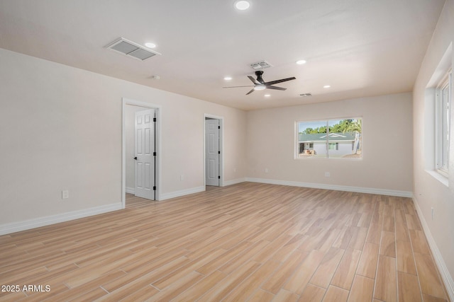 spare room featuring light wood-type flooring and ceiling fan