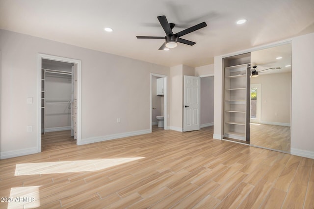 unfurnished bedroom with ensuite bath and ceiling fan