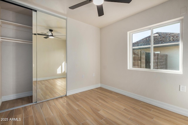 unfurnished bedroom featuring ceiling fan and a closet