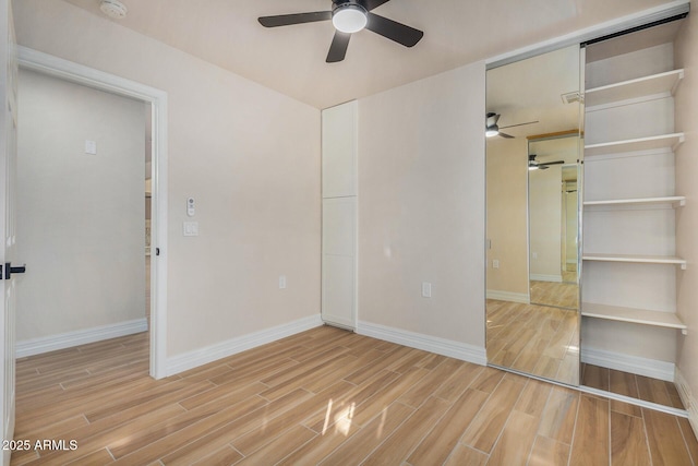 unfurnished bedroom with ceiling fan and a closet