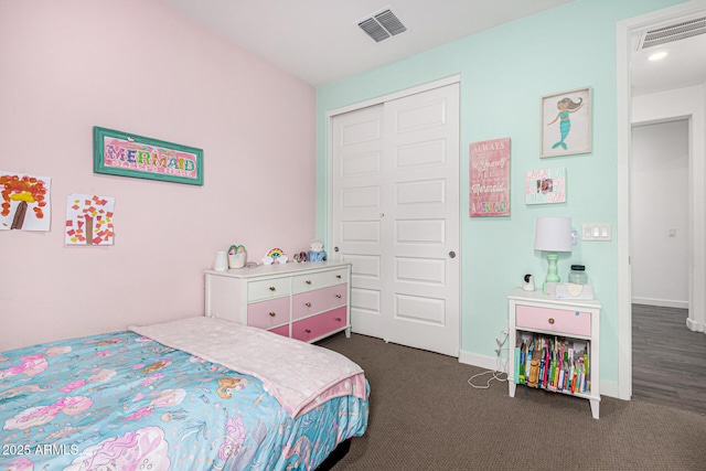 carpeted bedroom with a closet, visible vents, and baseboards