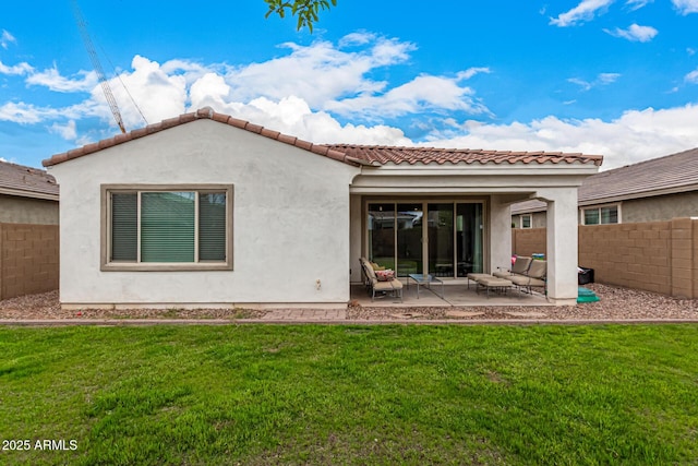 back of house featuring a patio area, stucco siding, a lawn, and fence