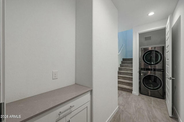 laundry area featuring stacked washer and dryer