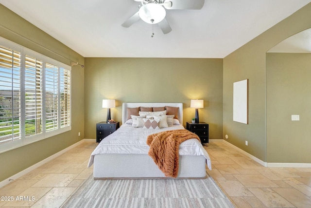 3531 E Norwood Cir, Mesa, AZ 85213 - bedroom featuring stone tile flooring, arched walkways, baseboards, and ceiling fan