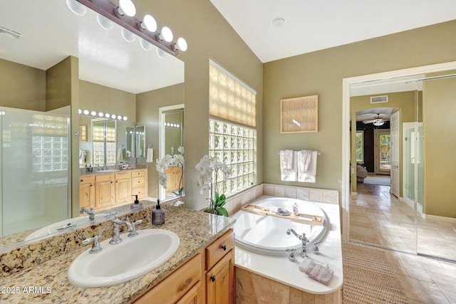 3531 E Norwood Cir, Mesa, AZ 85213 - bathroom with plenty of natural light, vanity, a garden tub, and stone tile flooring
