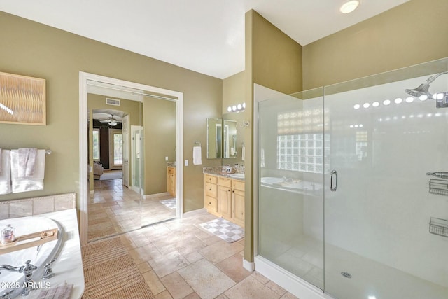 3531 E Norwood Cir, Mesa, AZ 85213 - full bath featuring vanity, a shower stall, a bath, baseboards, and a ceiling fan