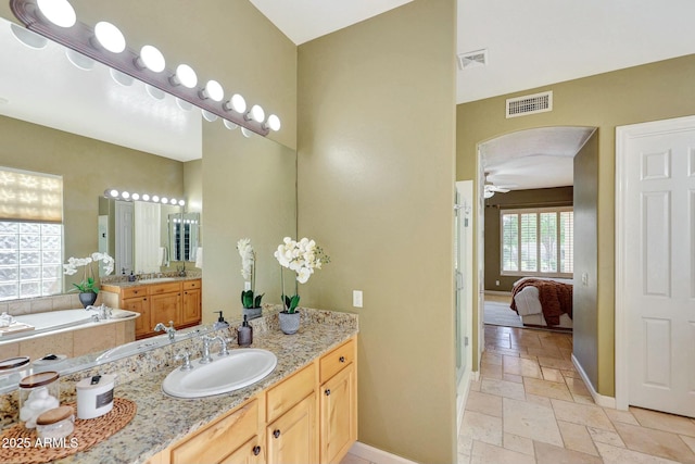 3531 E Norwood Cir, Mesa, AZ 85213 - ensuite bathroom with baseboards, stone tile floors, vanity, a bath, and a ceiling fan