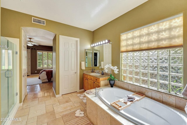 3531 E Norwood Cir, Mesa, AZ 85213 - full bath with a garden tub, vanity, stone tile floors, ceiling fan, and a shower stall
