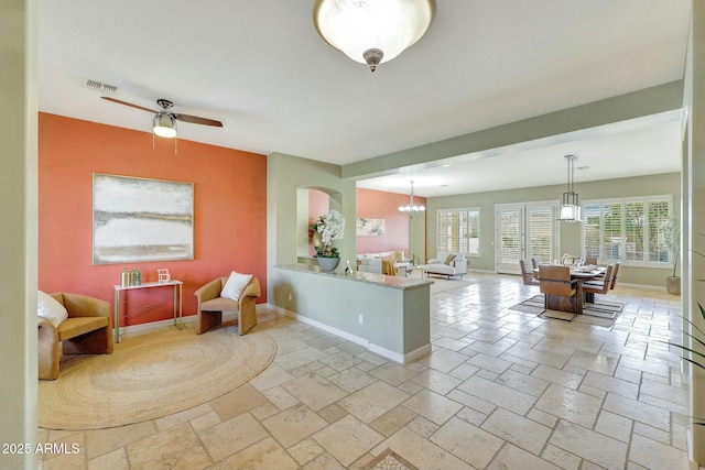 3531 E Norwood Cir, Mesa, AZ 85213 - living area featuring baseboards, stone tile flooring, and a chandelier