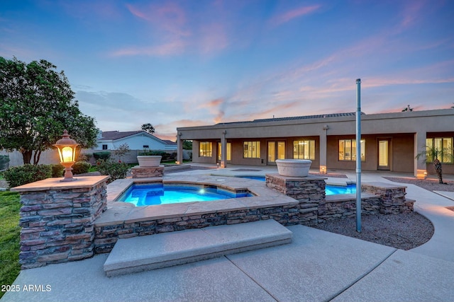 3531 E Norwood Cir, Mesa, AZ 85213 - pool at dusk with an in-ground hot tub, a patio area, and an outdoor pool