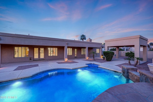 3531 E Norwood Cir, Mesa, AZ 85213 - pool at dusk featuring a patio area and a hot tub