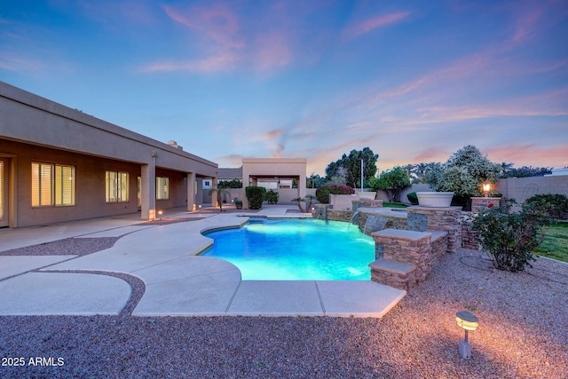3531 E Norwood Cir, Mesa, AZ 85213 - pool at dusk with a patio area, an outdoor kitchen, and a fenced backyard