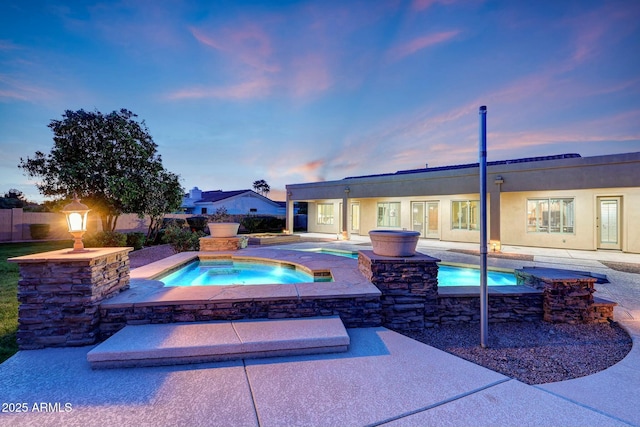 3531 E Norwood Cir, Mesa, AZ 85213 - pool at dusk with an in-ground hot tub and a patio area
