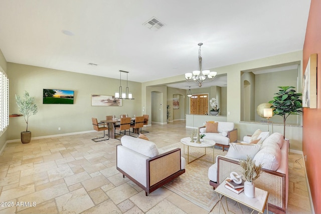 3531 E Norwood Cir, Mesa, AZ 85213 - living room with a chandelier, baseboards, and stone tile floors