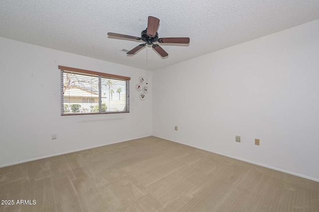 spare room with light carpet and a textured ceiling