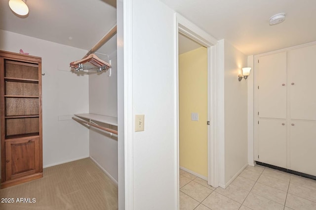 spacious closet with light tile patterned flooring