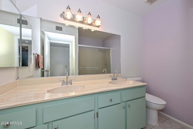 bathroom featuring toilet, a sink, and visible vents