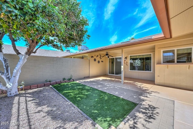 exterior space with a ceiling fan and a fenced backyard