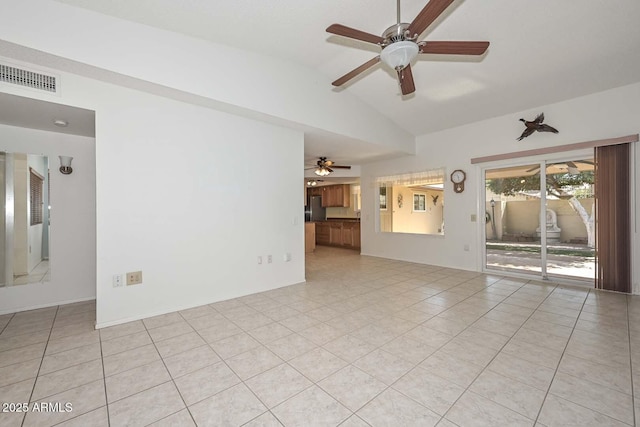 unfurnished room with lofted ceiling, visible vents, ceiling fan, and light tile patterned floors