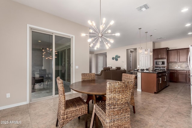 dining room with an inviting chandelier, baseboards, visible vents, and light tile patterned flooring