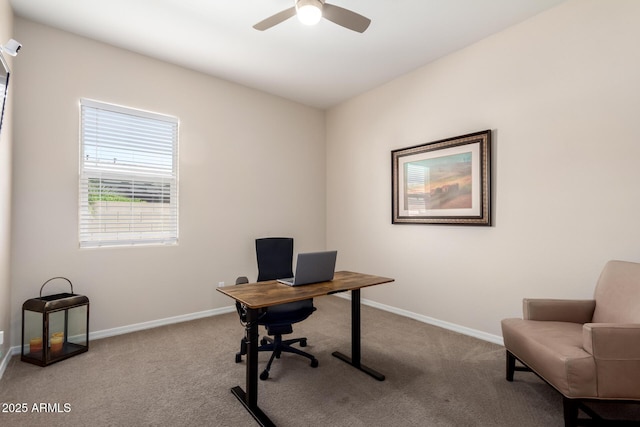 carpeted home office featuring ceiling fan and baseboards