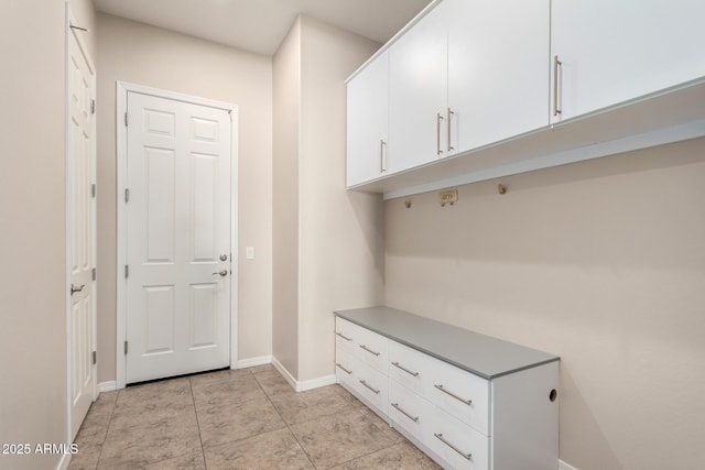 mudroom with light tile patterned floors and baseboards