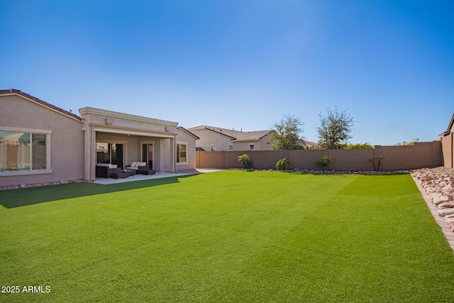 view of yard featuring a patio area, a fenced backyard, and outdoor lounge area