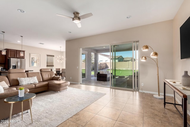 living area with light tile patterned floors, recessed lighting, a ceiling fan, and baseboards