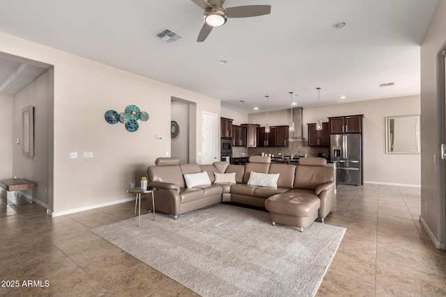 living room featuring baseboards, visible vents, and light tile patterned flooring