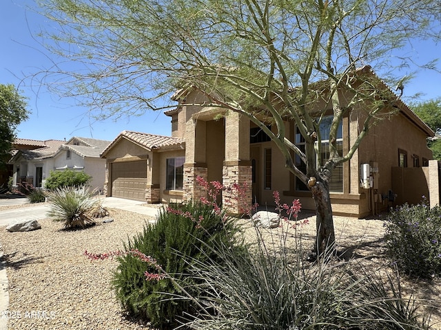 33506 N 24th Dr, Phoenix, AZ 85085 - view of front of home with stucco siding, driveway, an attached garage, and a tile roof