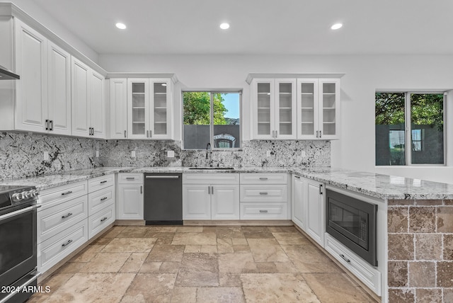 kitchen featuring sink, white cabinetry, stainless steel appliances, and plenty of natural light