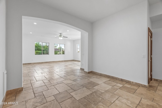 unfurnished room with ceiling fan