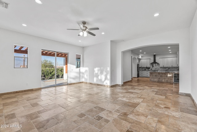 empty room with wine cooler and ceiling fan