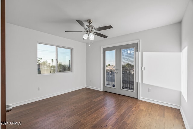 unfurnished room featuring french doors, dark hardwood / wood-style floors, and a healthy amount of sunlight