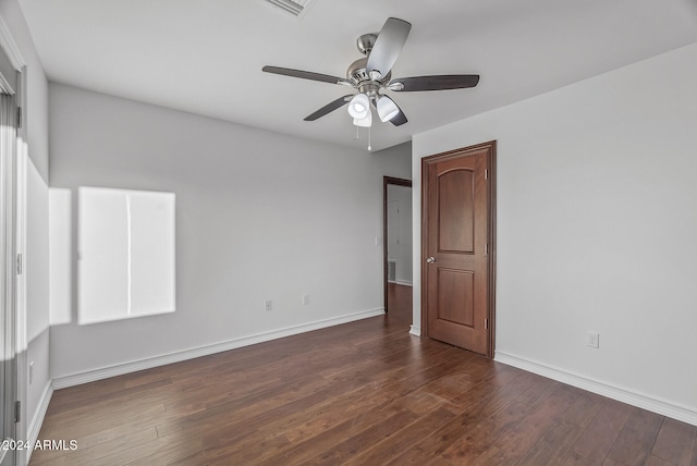 spare room with dark hardwood / wood-style floors and ceiling fan