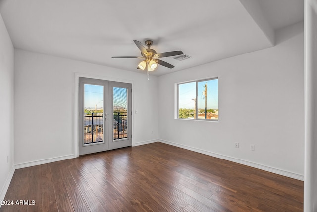 spare room with dark wood-type flooring, ceiling fan, and french doors